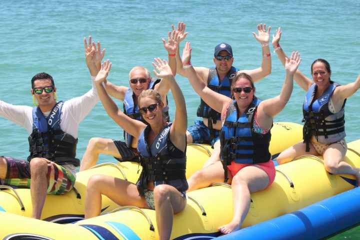a group of people sitting on a boat in the water