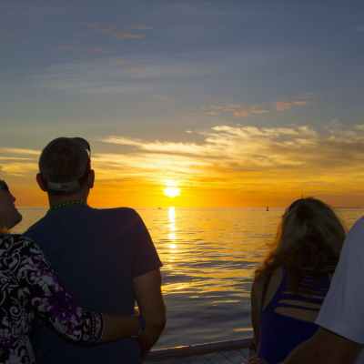 a group of people standing next to a body of water