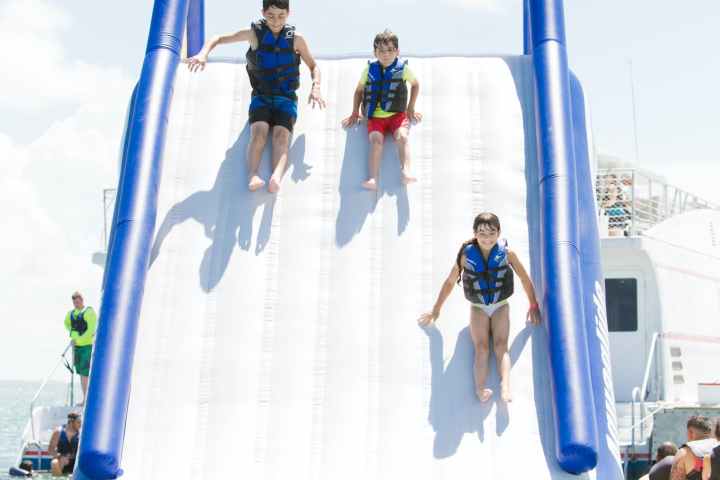 a group of people riding on the back of a boat